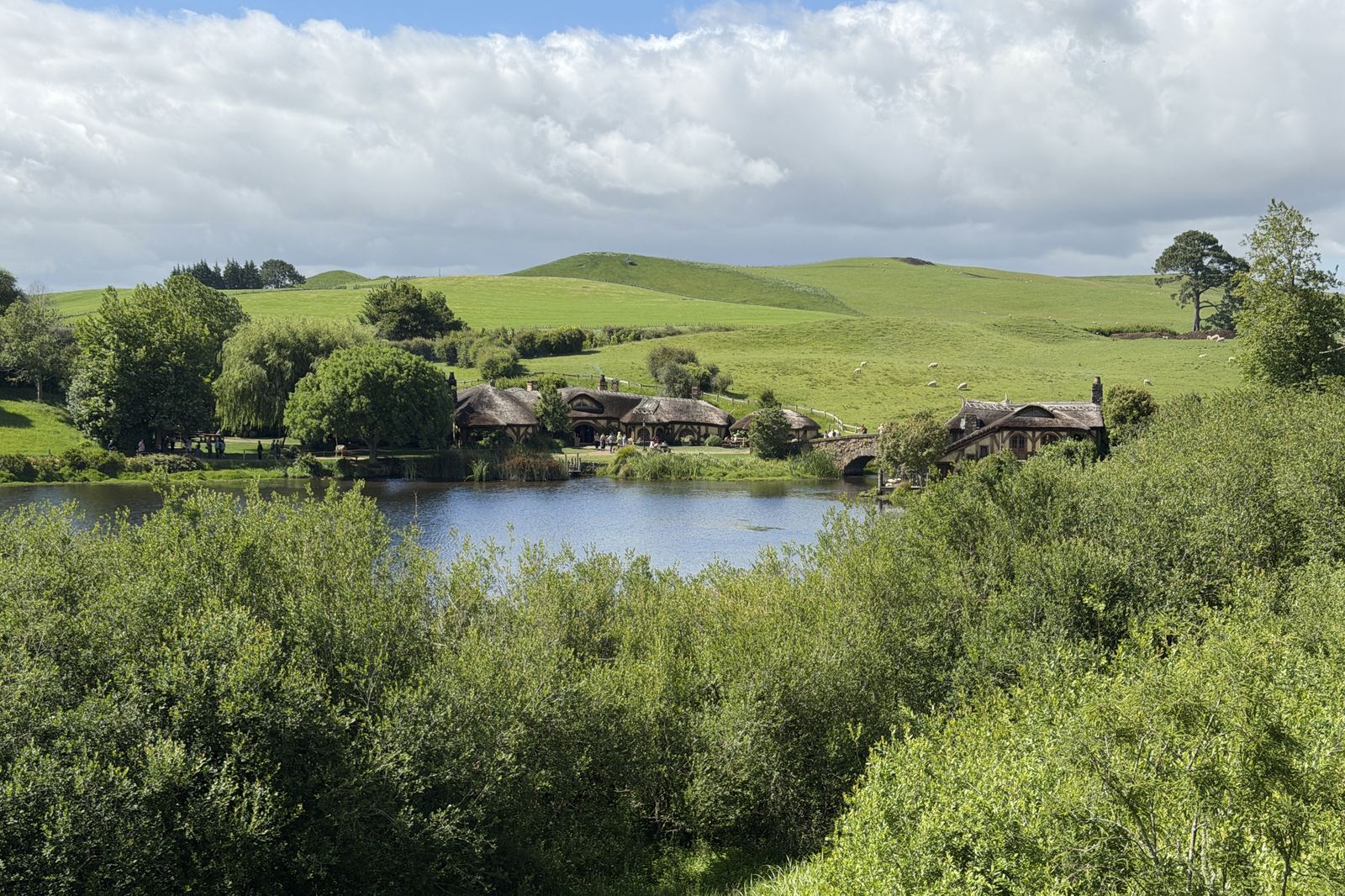 Hobbiton in New Zealand: hobbit holes beside a lake, 2025.